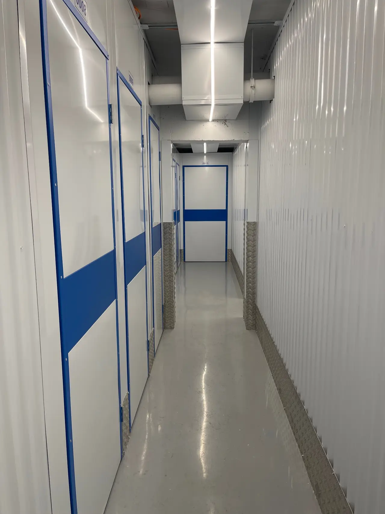 Modern self-storage cellar corridor with LED lighting